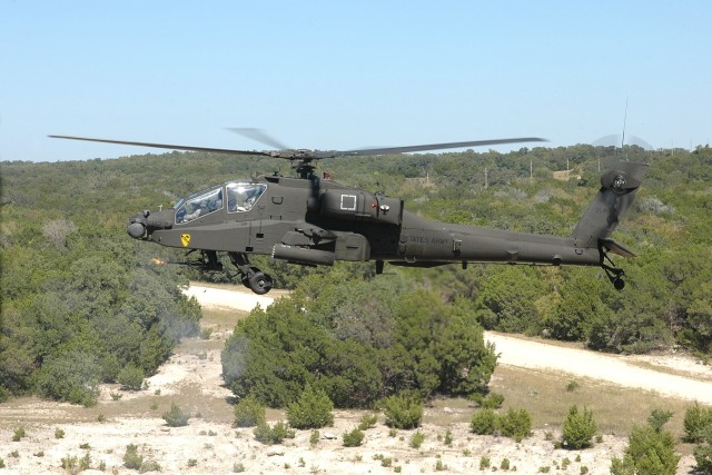 An AH-64D Apache attack helicopter from the 4th "Guns" Battalion, 227th Aviation Regiment, 1st Air Cavalry Brigade, 1st Cavalry Division, lets loose a stream of 30 mm rounds from its chain gun during an aerial gunnery at Fort Hood, Texas, Oct 8....
