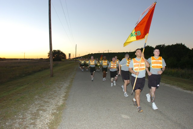 Even before the sun peaks over the horizon, the troopers of the 1st Air Cavalry "Warrior" Brigade, 1st Cavalry Division, head out on a unit run at West Fort Hood, Texas, to boost morale before their four-day weekend, Oct 9.  Colonel Douglas...