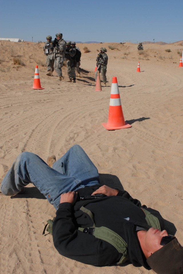 'Diablo' Soldiers from Delta Company, 2nd Battalion, 5th Cavalry Regiment, 1st Brigade Combat Team, 1st Cavalry Division, cautiously approach an actor portraying a wounded hostile civilian after he opened fire with a hand gun inside of their...