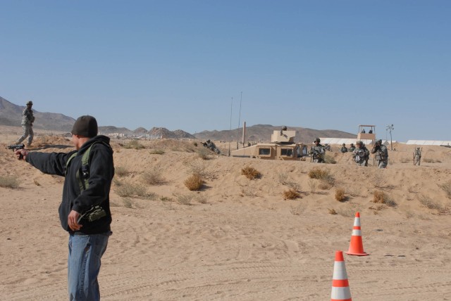 Soldiers from Delta Company 2nd Battalion, 5th Cavalry Regiment, 1st Brigade Combat Team, 1st Cavalry Division, take aim as an actor portraying a civilian with hostile intent opens fire inside of their controlled entry point at the National...
