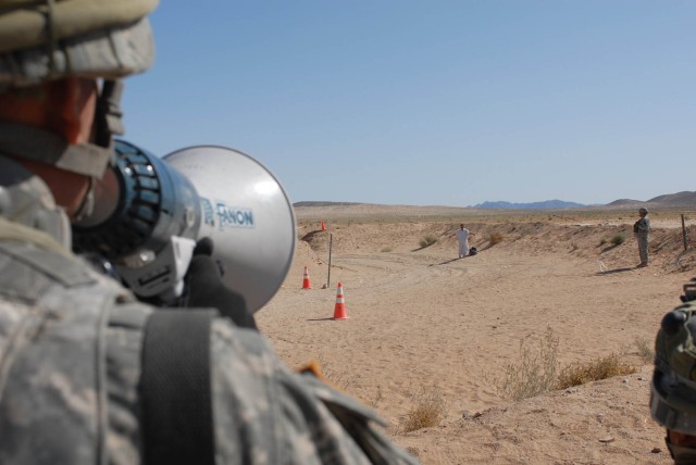 A translator with 1st Platoon, Delta Company, 2nd Battalion, 5th Cavalry Regiment, 1st Brigade Combat Team, 1st Cavalry Division, gives instruction to an "Iraqi" civilian at FOB Denver's entry control point Oct. 12. This was a part of scenario...