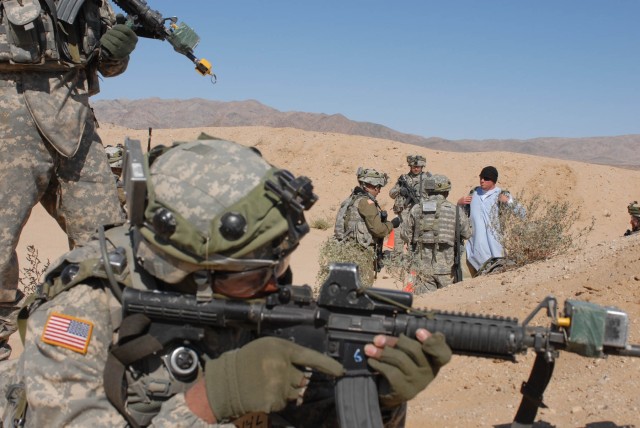 Spc. Mario Alberto Ontivelious, a gunner with1st Platoon, Delta Company, 2nd Battalion, 5th Cavalry Regiment, 1st Brigade Combat Team, 1st Cavalry Division, pulls security at FOB Denver's entry control point as his platoon sergeant and interpreter...