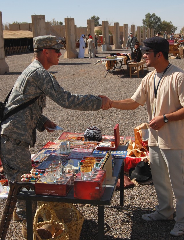Soldier meets vendor at Iraqi souk