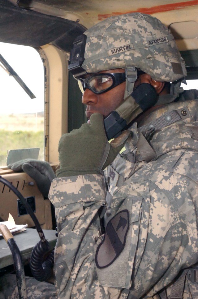 Springdale, N.C. native, Staff Sgt. Derrick Martin, a squad leader for Battery A, 3rd Battalion, 82nd Field Artillery Regiment, 2nd Brigade Combat Team, 1st Cavalry Division, communicates with the range tower to coordinate his squad's turn on the ran...