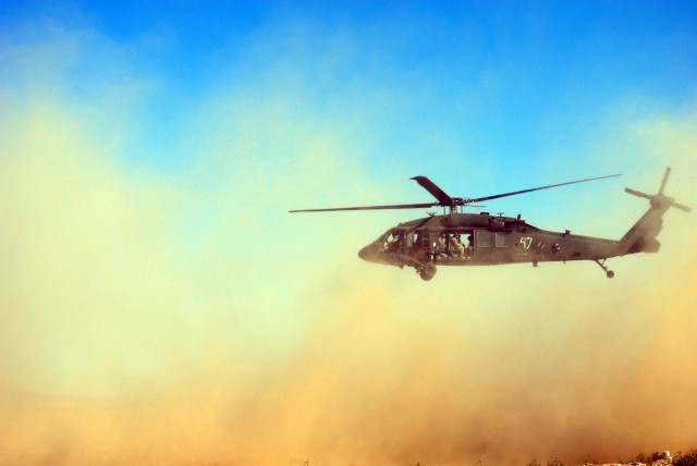 A UH-60 Blackhawk Helicopter takes off outside a mock training city at Ft. Irwin, Calif. Oct. 13. The Blackhawk was used to transport Soldiers from 2nd "Lancers" Battalion, 5th Cavalry Regiment, 1st Brigade Combat Team, 1st Cavalry Division's...