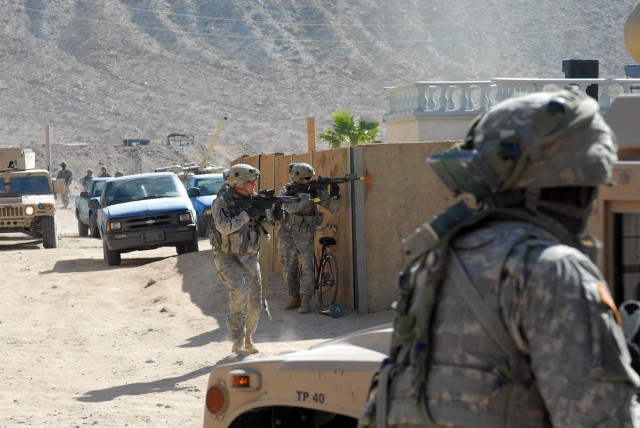 Philadelphia, Pa. native Spc. Joseph Ryan Dunbar, a tanker with Delta Company, 2nd "Lancers" Battalion, 5th Cavalry Regiment, 1st Brigade Combat Team, 1st Cavalry Division, runs to take cover behind a humvee on the streets of Medina Jabal, as his...