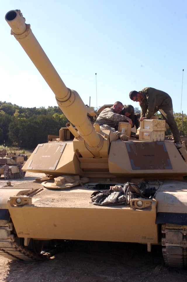 Soldiers from the 1st Battalion, 5th Regiment, 2nd Brigade Combat Team, 1st Cavalry Division load ammunition on to their tank before it returns to the range on Oct. 22 at Sugarloaf Multi-Use Range on Fort Hood. The Soldiers are training on all...