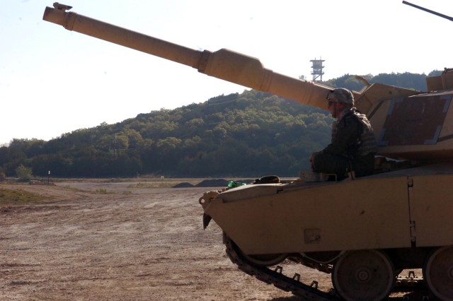 A canon crew member for Company C, 1st Battalion, 5th Regiment, 2nd Brigade Combat Team, watches as other Soldiers go through the range on Oct. 22 at Sugar Loaf Multi-Use Range on Fort Hood. The Soldiers are practicing various tank operations in...