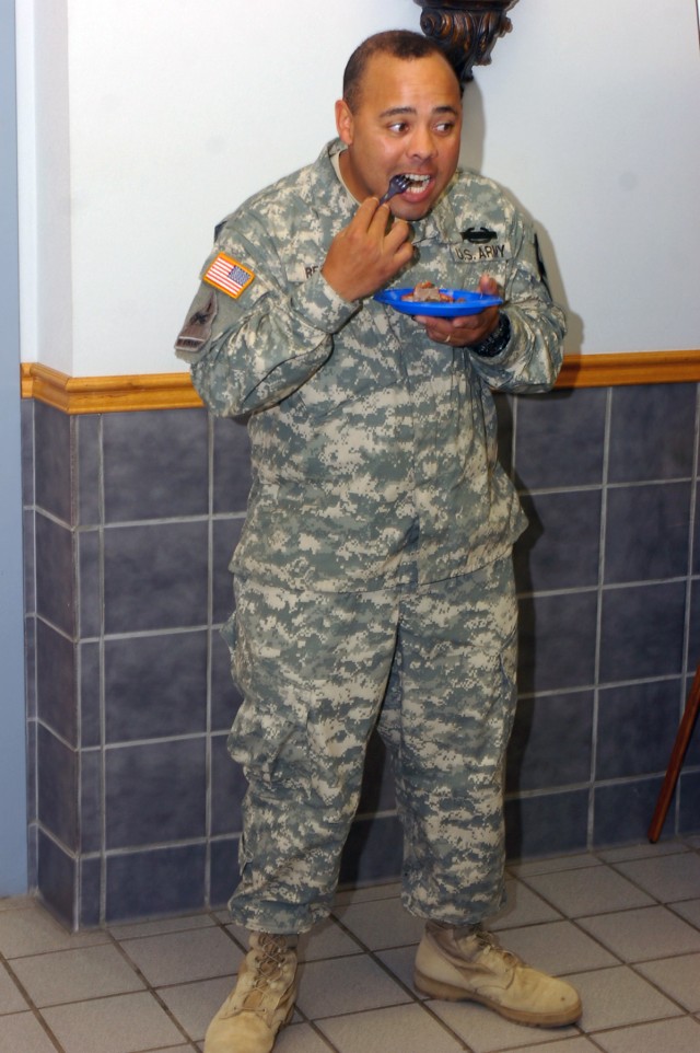 Rio Grande, Puerto Rico native Staff Sgt. Jose Y. Resto, the Equal Opportunity Advisor for the 1st Battalion, 8th Cavalry Regiment, 2nd Brigade Combat Team, 1st Cavalry Division, samples the food brought by local vendors at the Hispanic American Heri...