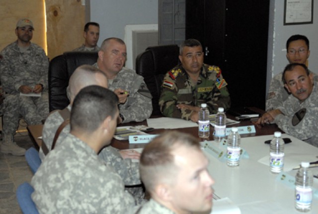 Lt. Col. Timothy Daugherty, commander of the 5th Battalion, 82nd Field Artillery Regiment, 4th Brigade Combat Team, 1st Cavalry Divison, speaks with Col. Mumamad Jasim, commander of the 41st Iraqi Army Brigade, about current operations during a meeti...