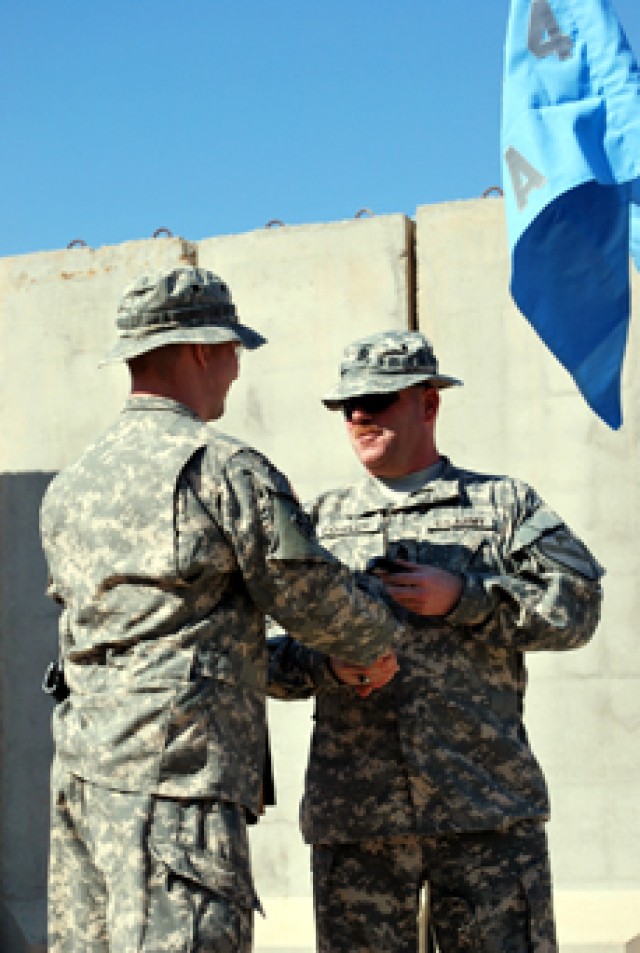 1st Sgt. Eric Fowler, from Alpha Company, 4th Brigade Special Troops Battalion, 4th Brigade Combat Team, 1st Cavalry Division congratulates his former company commander, Cpt. Jason Meisel from Newark, Oh., on a successful 20 months of command as he i...