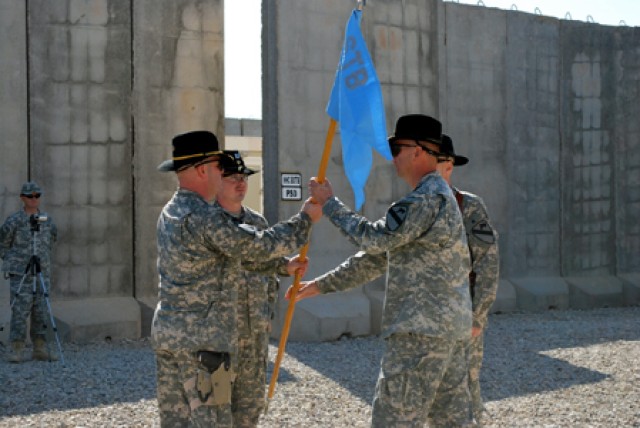 Cpt. Kent Lane, a native of Norman, Ok., and the new incoming company commander of Alpha Company, 4th Brigade Special Troops Battalion, 4th Brigade Combat Team, 1st Cavalry Division passes the Guidon off to 1st Sgt. Eric Fowler, the alpha company fir...
