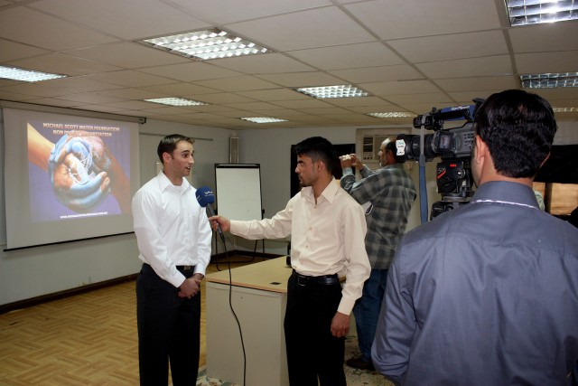 Josh Mater conducts an interview with Iraqi media on the efforts of the Michael Scott Mater Foundation to establish a relationship between Oregon State University and Dhi Qar University Nov. 11 near Nasiriyah.  Mater brought some donated academic...