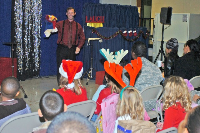 Tim Cowles, a ventriloquist, and his puppet parrot entertain kids and Soldiers at the 15th Sustainment Brigade, 13th Sustainment Command (Expeditionary), junior family readiness group event Dec. 5. The puppet show encouraged kids to be respectful...