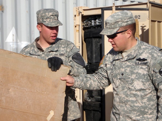Appleton, Wis. Native Pfc. Daniel Wolf (left), a radio transmission operator receives direction from veteran and Coshocton, Ohio native Spc. Robert Rizer (right), a Bradley driver, both from Headquarters and Headquarters Troop, 1st Brigade Combat Tea...