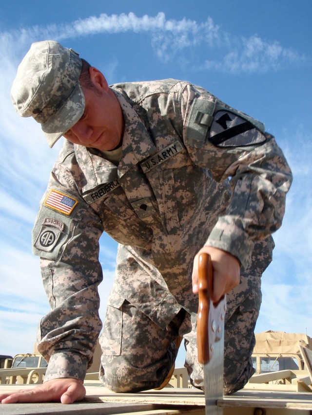 Dauphin Island, Ala. native Spc. Aaron Frederick, a senior Early Warning System Operator for Headquarters and Headquarters Troop, 1st Brigade Combat Team, 1st Cavalry Division cuts a piece of plywood in order to properly secure the containers that wi...