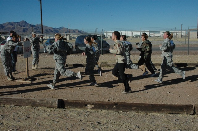Fort Bliss spouses on obstacle course