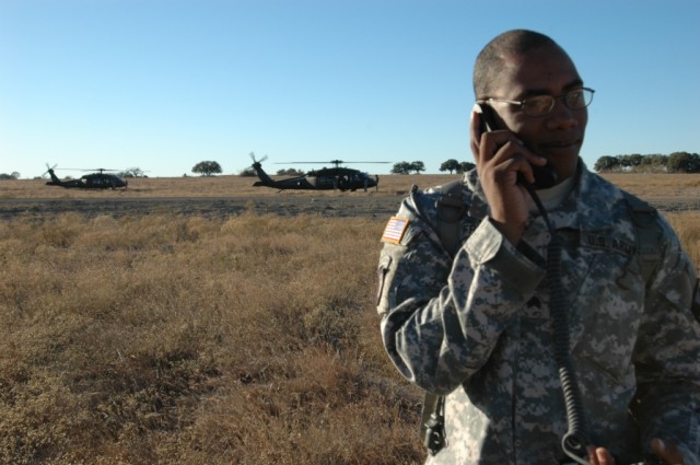 Sacramento, Calif. native, Sgt. Lonnie Friend, the assistant aviation operations sergeant for 1st Brigade Combat Team, 1st Cavalry Division, coordinates the arrival of UH-60 "Blackhawk" helicopters from Troop A, 3rd Battalion ,227th Aviation Regiment...