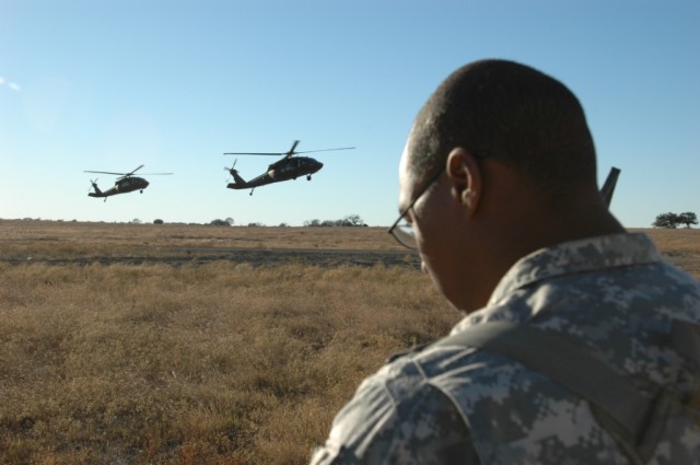 Sacramento, Calif. native, Sgt. Lonnie Friend, the assistant aviation operations sergeant for 1st Brigade Combat Team, 1st Cavalry Division, coordinates the arrival of UH-60 "Blackhawk" helicopters from Troop A, 3rd Battalion ,227th Aviation Regiment...