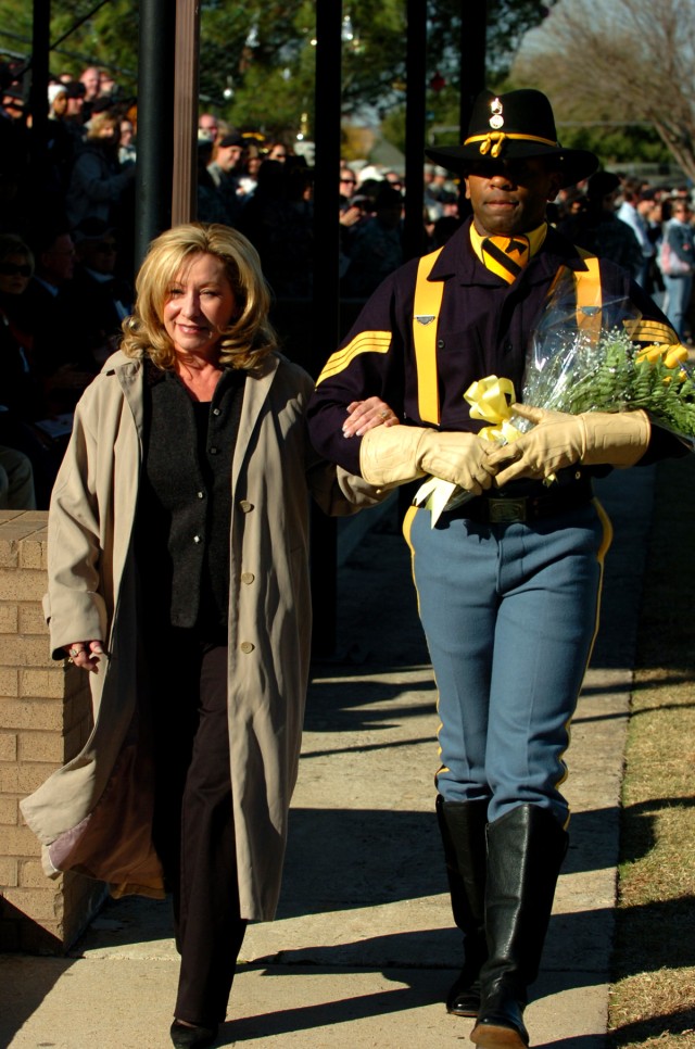 Rock Hill, S.C. native, 1st Cavalry Division Honor Guard, Non-Commissioned Officer in Charge, Staff Sgt. Hal Spiller, escorts Lt. Gen. Rick Lynch's wife Sarah to present a bouquet of yellow roses to the 1st Cavalry Division Commander's wife, Joy...