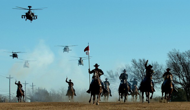 Following the casing of the brigade, battalion and division colors, the 1st Cavalry Division Horse Detachment Soldiers perform a cavalry charge accompanied by a fly-over performed by the 1st Cavalry Division Air Cavalry Brigade on Fort Hood's Cooper ...