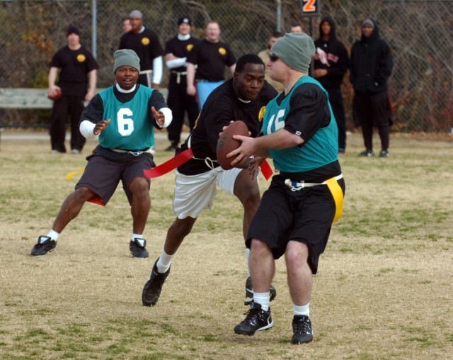 Soldiers from 3rd Battalion, 82nd Field Artillery, 2nd Brigade Combat Team, 1st Cavalry Division play a game of tag football. The Soldiers are taking part of a battalion sports day on Dec. 13. The sports day gave families and Soldiers a chance to rel...