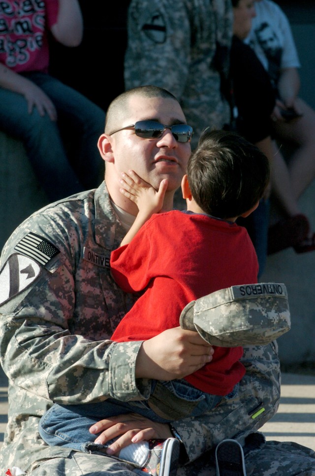 Spc. Jacob Ontiveros, a heavy equipment operator with Company A, 15th Brigade Support Battalion, 2nd Brigade Combat Team, 1st Cavalry Division, spends a few moments with his 5-year-old son Jonah outside Howze Theater Jan. 3. This is the Odessa, Texas...