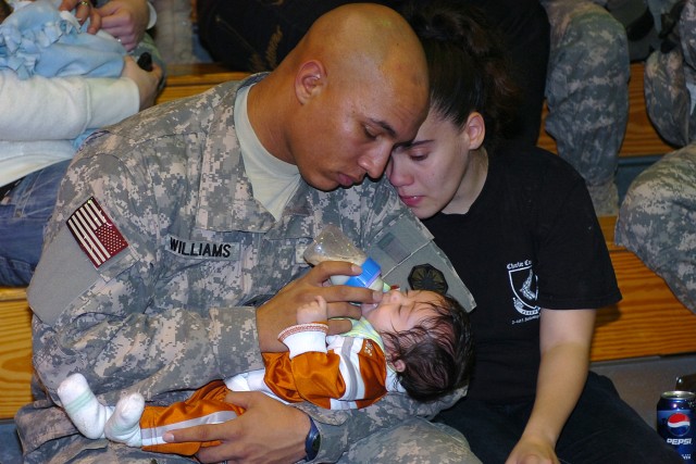 Pfc. Anthony Williams, a Cliffwood, N.J., native truck driver with the 154th Transportation Company, 180th Transportation battalion, 15th Sustainment Brigade, 13th Sustainment Command (Expeditionary), feeds his 4-month-old daughter Alexandria with...
