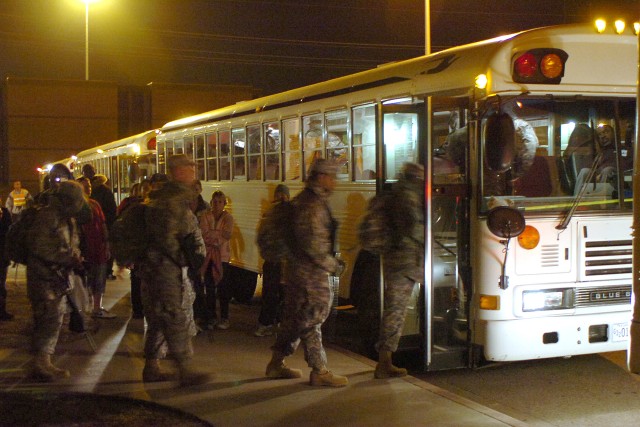 Soldiers from the 664th Ordnance Company, 180th Transportation Battalion, 15th Sustainment Brigade, 13th Sustainment Command (Expeditionary), board buses bound for the Robert Gray Army Airfield on Fort Hood, following a deployment ceremony Dec....