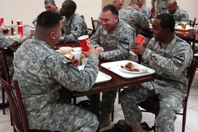 Soldiers from 2nd Brigade Combat Team, 1st Cavalry Division, enjoy lunch at the dining facility at Camp Buehring, Kuwait. The camp's dining facility has an assortment of food including a Salad bar, potato bar, various drinks and choices for...