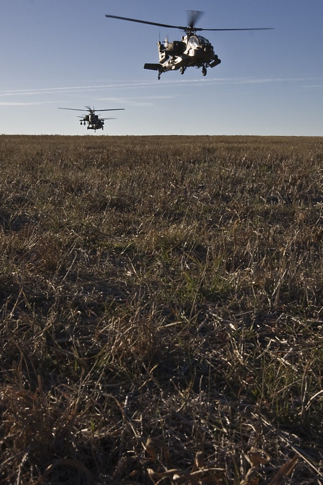 Two AH-64D Apache attack helicopters from 1st Attack Reconnaissance Battalion, 227th Aviation Regiment, 1st Air Cavalry Brigade, 1st Cavalry Division, along with one UH-60 Black Hawk from 3rd Assault Helicopter Battalion, 227th Aviation Regiment, 1st...