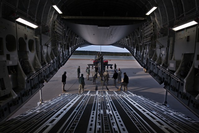 Soldiers from 1st Attack Reconnaissance Battalion, 227th Aviation Regiment, 1st Air Cavalry Brigade, 1st Cavalry Division, begin loading an AH-64D Apache attack helicopter on an Air Force C-17 Globemaster III, Robert Gray Army Airfield, Fort Hood, Te...