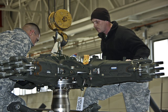 Heavy unscheduled maintenance starts off the New Year for these Soldiers in Company D, 1st Attack Reconnaissance Battalion, 227th Aviation Regiment, 1st Air Cavalry Brigade, 1st Cavalry Division. Staff Sgt. Adam Parker (right) a native of Harker Heig...