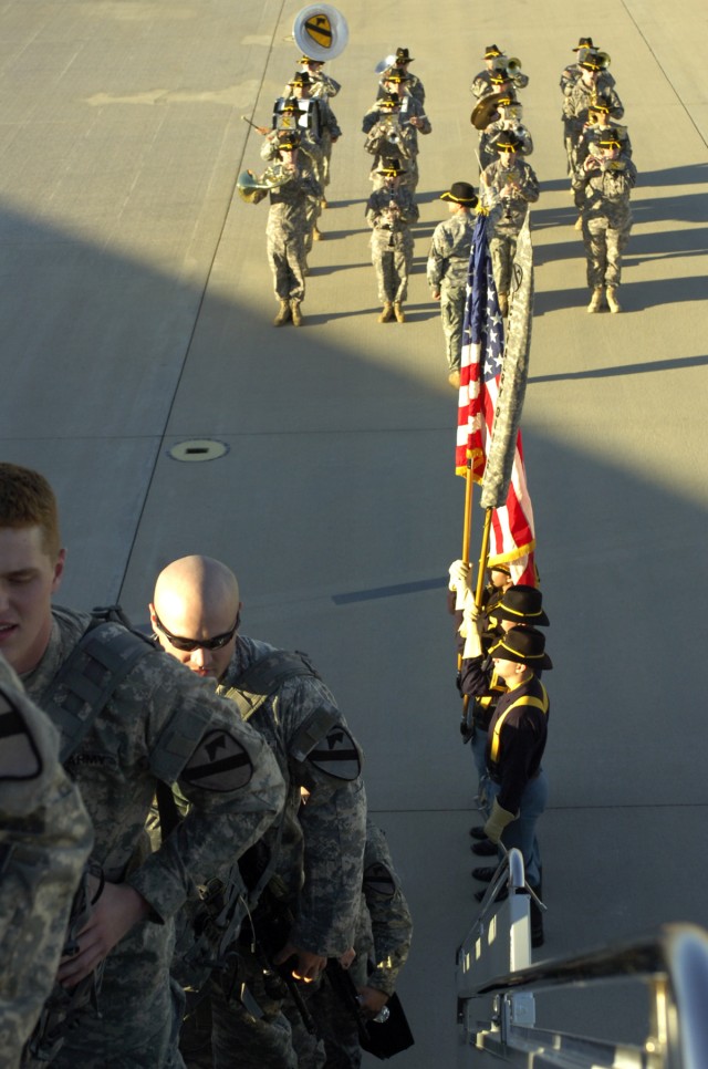 The 1st Cavalry Division Band and Honor Guard salute the Soldiers from the 1st Cavalry Division's 2nd Brigade Combat Team as they board their flight to Kuwait at Fort Hood's Robert Gray Army Airfield Jan. 8 on the first step toward their 12-month...
