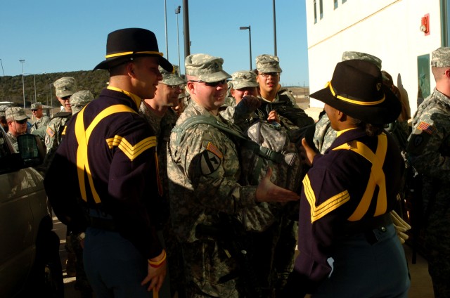 Soldiers from the 2nd Brigade Combat Team, 1st Cavalry Division receive congratulatory handshakes and words of encouragement Jan. 8 at Fort Hood, Texas from members of the 1st Cavalry Division Honor Guard, before flying to the sands of Iraq for a...