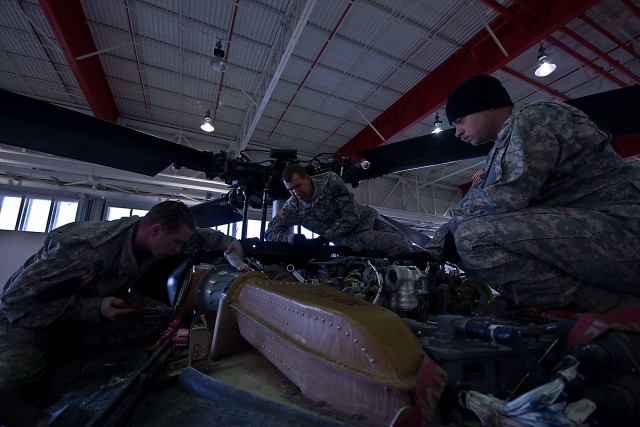 During a troubleshooting procedure for a UH-60 Black Hawk helicopter main rotor flight control problem, Spc. Kevin Parrot (right) of Riverdale, Ga., Spc. Dale Snedacor (middle) of Odessa, Texas and Sgt. Jordan Downey (left) of Valders, Wis., all...