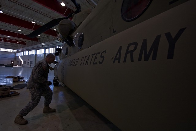 Spc. Duane Topping of Denver, a Soldier in Company D, 2nd General Support Aviation Battalion, 227th Aviation Regiment, 1st Air Cavalry Brigade, 1st Cavalry Division, starts to reinstall aircraft panels as he completes his portion of a 180-day...