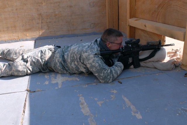 Staff Sgt. Michael Lashua, from Walker, La., a cavalry scout and squad designated marksman with Troop B, 4th Squadron, 9th Cavalry Regiment, 2nd Brigade Combat Team, 1st Cavalry Division, prepares to fire his M-4 rifle from the top floor of a buildin...