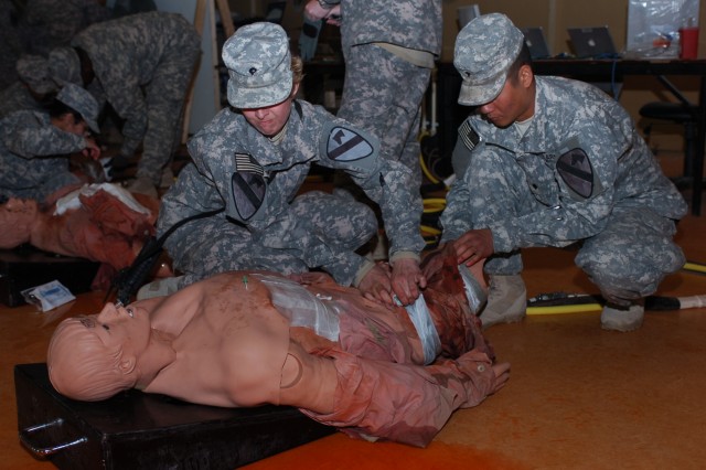 Alcona, Mich. native Spc. Amanda Ranke, a medic for Company C, 15th Brigade Support Battalion, 2nd Brigade Combat Team, 1st Cavalry Division and Saipan native Spc. Jeffrey Santos, a medical supply specialist for Company C, practice life saving...