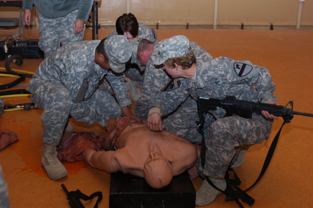 Soldiers from Company C, 15th Brigade Support Battalion, 2nd Brigade Combat Team, 1st Cavalry Division, check the vital signs on a mannequin during training Jan. 18 on Camp Buehring. The Soldiers learned how to apply tourniquets, check breathing...