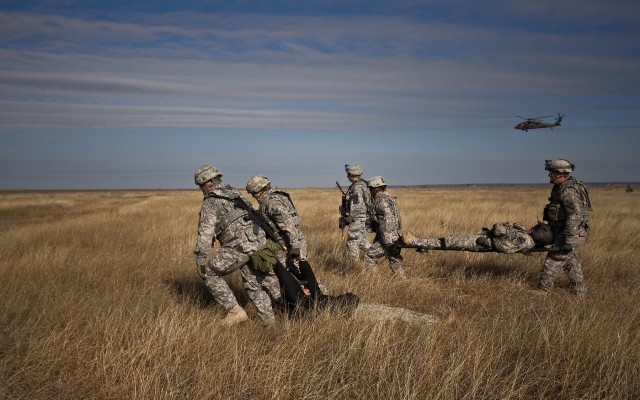 A UH-60 Black Hawk helicopter provides aerial security for Soldiers in Company F, 3rd Helicopter Assault Battalion, 227th Aviation Regiment, 1st Air Cavalry Brigade, 1st Cavalry Division, as they move wounded Soldiers during a downed aircraft...