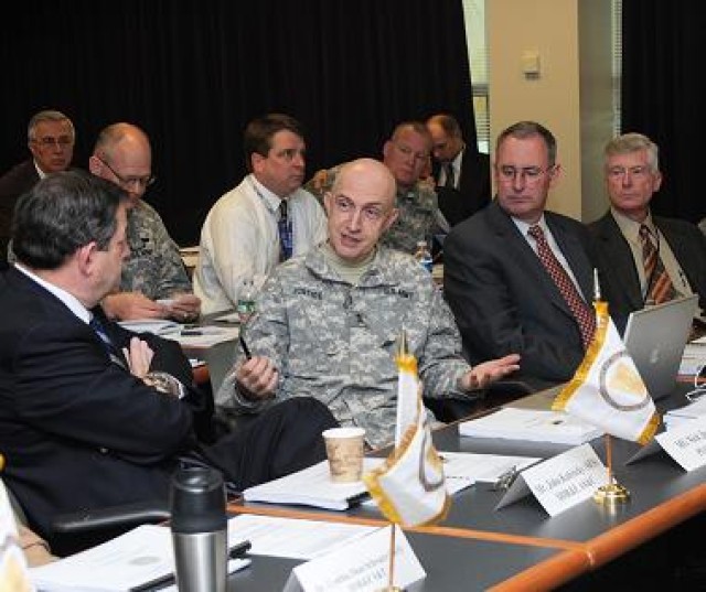 Senior Officer of PEO C3T, Maj. Gen. Nick Justice, emphasizes a point to John Kubricky, Director of Defense Research and Engineering Advanced Systems and Concepts. Michael Krieger, the Army Deputy Chief Information Officer/G6 and other attendees list...