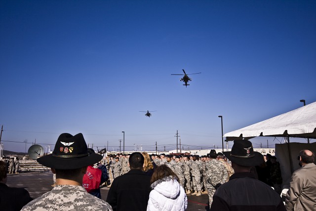Two AH-64D Apache attack helicopters from 4th Attack Reconnaissance Battalion, 227th Aviation Regiment, 1st Air Cavalry Brigade, 1st Cavalry Division perform a fly-over for a missing man formation during a building dedication ceremony on Jan. 28,...