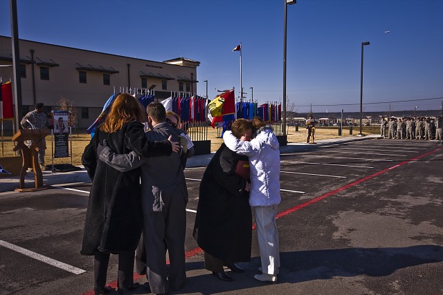 Jasmine Crowl (white jacket), mother of Chief Warrant Officer 3 Cornell Chao, and Carol Resh, mother of Capt. Mark Resh, embrace each other outside of the headquarters buildings of the 1st Air Cavalry Brigade, 1st Cavalry Division, at Fort Hood,...