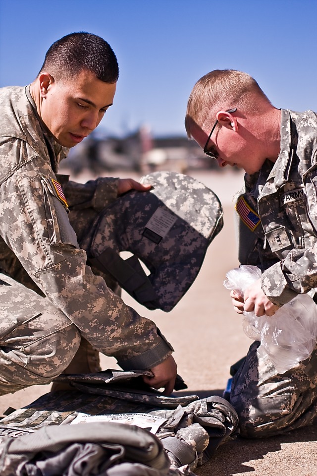 Chief Warrant Officer 2 Larry Sarmieto (left), of Company C, 4th Attack Reconnaissance Battalion, 227th Aviation Regiment, 1st Air Cavalry Brigade, 1st Cavalry Division, of Plant City, Fla., CW2 Ryan Williams (right), of Company B, 4-227th ARB, Portv...