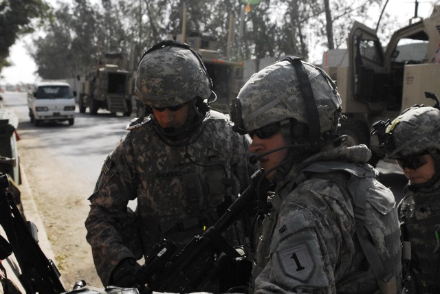 Sgt. Patrick Chambers, who hails from Denton, Texas, personal security detachment team leader, 2nd Heavy Brigade Combat Team, 1st Infantry Division, Multi-National Division-Baghdad, inspects the chamber of a Soldier's weapon prior to a mission in the...