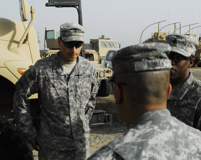 Sgt. Patrick Chambers (left), a native of Denton, Texas, personal security detachment team leader, 2nd Heavy Brigade Combat Team, 1st Infantry Division, Multi-National Division-Baghdad, receives a brief from his team leader prior to a mission in the ...