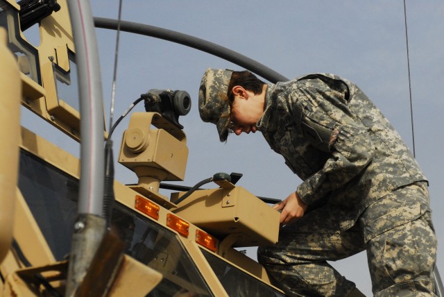 BAGHDAD - Spc. Giselle King, a communications specialist with Company B, Brigade Special Troops Battalion, 2nd Heavy Brigade Combat Team, 1st Infantry Division, Multi-National Division-Baghdad, works with the radio equipment on a "Dagger" Brigade...