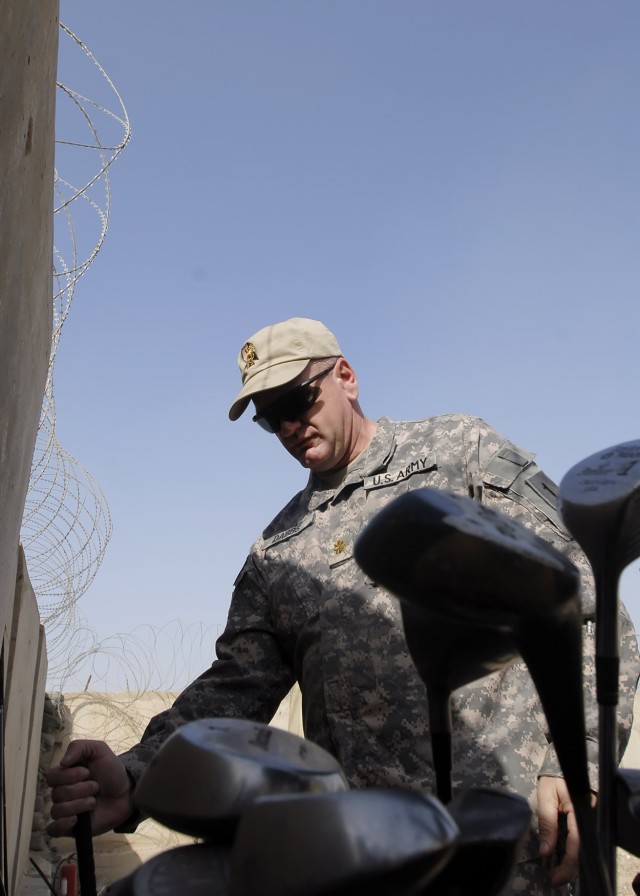 Maj. Matthew Dabbs, a native of Jacksonville, Ala., operations officer, 2nd Heavy Brigade Combat Team, 1st Infantry Division, Multi-National Division-Baghdad, inspects golf clubs at the new "Dagger" driving range on Camp Liberty Feb. 8. Brigade leade...