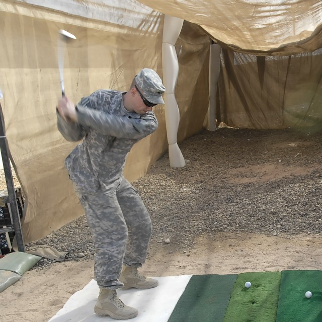 Sgt. Ryan Greve, of Charlotte, N.C., Headquarters Company, 2nd Heavy Brigade Combat Team, 1st Infantry Division, Multi-National Division-Baghdad, shows off his golf swing at the new "Dagger" driving range on Camp Liberty Feb. 8. The new range is a wa...